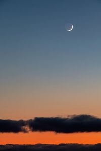 Low angle view of silhouette moon against sky at sunset
