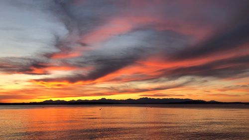 Scenic view of dramatic sky over sea during sunset