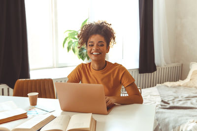 Young woman using laptop at home