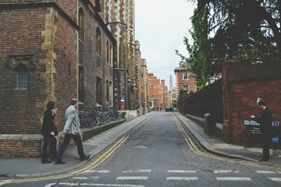 Woman walking on road in city