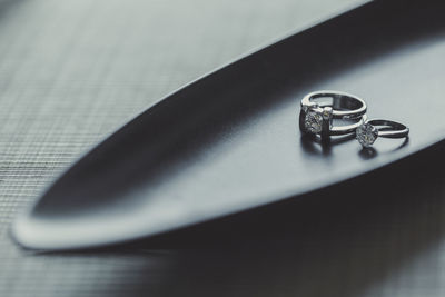 Close-up of wedding rings on table