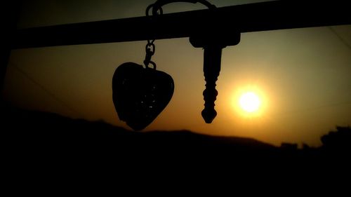 Low angle view of swing at sunset