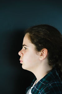 Close-up of girl against wall