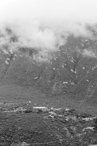 Scenic view of sea and mountains against sky