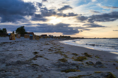 Scenic view of beach against sky during sunset