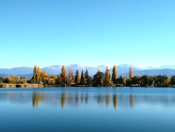 Scenic view of lake against clear blue sky