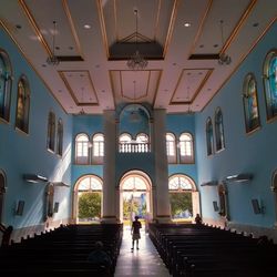 Rear view of people walking in building