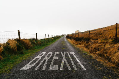 Concept of brexit. road marking with the word brexit painted on remote road a misty day. 