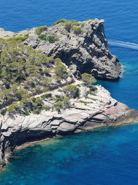 High angle view of rocks by sea