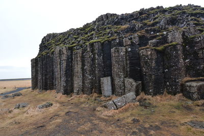 Rock formation on land against sky