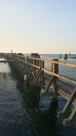 Pier on sea against clear sky