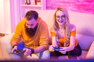 Portrait of smiling friends sitting at home