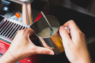 Cropped hands making coffee at table