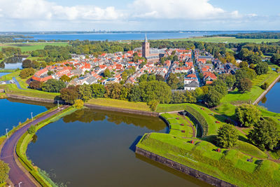 High angle view of river amidst buildings against sky