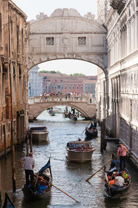 View of boats in canal along buildings