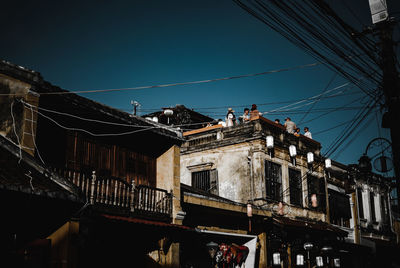 Low angle view of buildings against clear blue sky