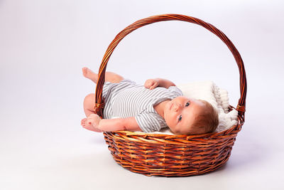 Boy wearing mask against white background