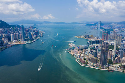 High angle view of city by sea against sky