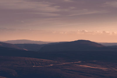 Scenic view of mountains against sky during sunset