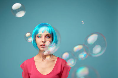 Portrait of young woman standing against sky