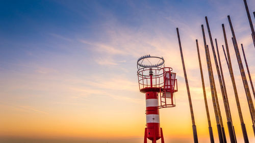 Lighthouse against sky during sunset