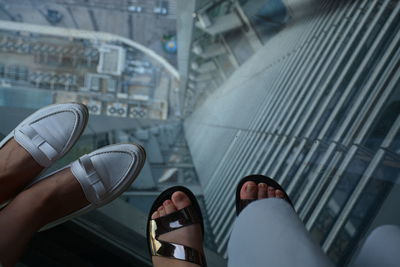 Low section of people on escalator in city