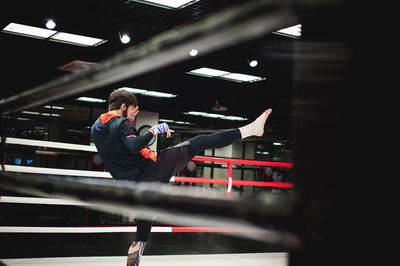 Man practicing boxing in ring