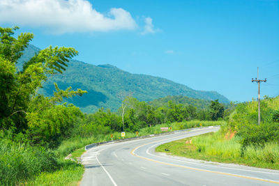 Road by mountain against sky