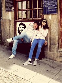 Portrait of young couple sitting outdoors