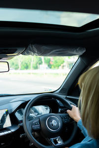 Reflection of woman in car mirror