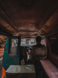 Rear view of man sitting in bus