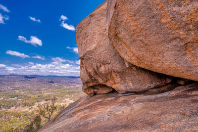 Rock formation on landscape against sky