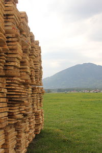 Stack of stones on field against sky