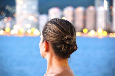 Woman standing in illuminated city at night