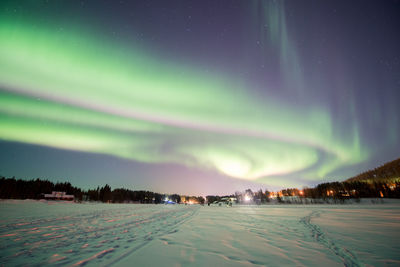 Scenic view of winter landscape against sky at night