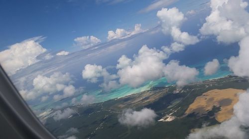 Aerial view of clouds and mountains against sky