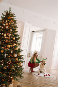 Portrait of woman with christmas tree