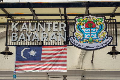 Low angle view of flags hanging against building