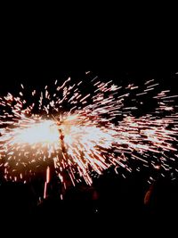 Low angle view of firework display at night