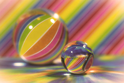 Close-up of crystal ball against colorful pattern