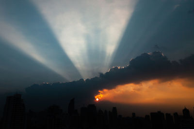 Silhouette buildings against sky during sunset