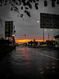 Wet road in city during sunset