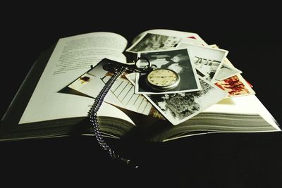 Close-up of open book against black background