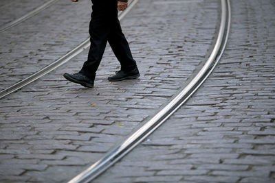 Low section of person walking on tramway