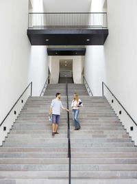 Young students walking on stairs