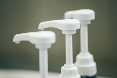 Close-up of soap dispensers in bathroom
