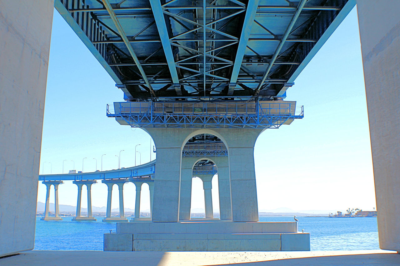 San Diego-Coronado Bay Bridge, arches, pillars, stanchions, pilings, girders, steel curved, traffic, sailboats, underneath, San Diego, California,