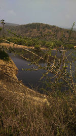 Scenic view of landscape and lake against sky