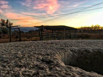 Close-up of sand against sky at sunset