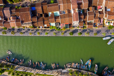 Drone view of river by buildings